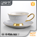 Elegant gold streak decorated ceramic cup and saucer set with hand